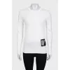 White jumper with gold decor on the sleeves