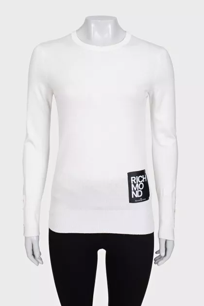 White jumper with gold decor on the sleeves