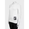 White jumper with gold decor on the sleeves