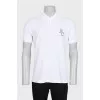 Men's white polo shirt with a patch