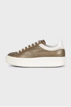 Gold sneakers with white soles
