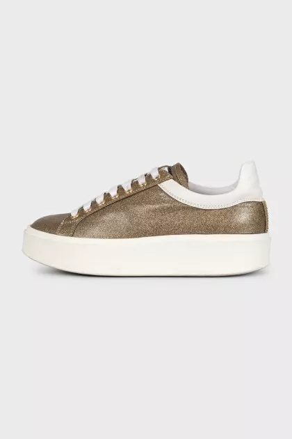 Gold sneakers with white soles