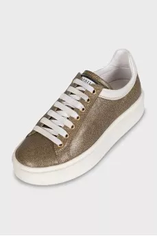Gold sneakers with white soles