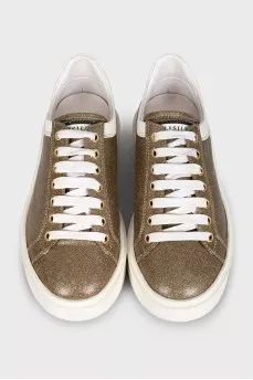 Gold sneakers with white soles