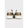 Gold sneakers with white soles