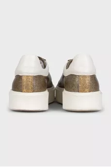 Gold sneakers with white soles