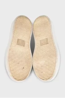Gold sneakers with white soles