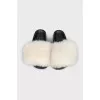Black flip-flops with white fur