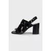 Black heeled sandals with gold hardware