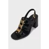 Black heeled sandals with gold hardware