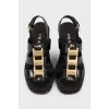 Black heeled sandals with gold hardware