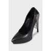 Leather high heels decorated with chains