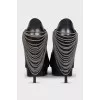 Leather high heels decorated with chains