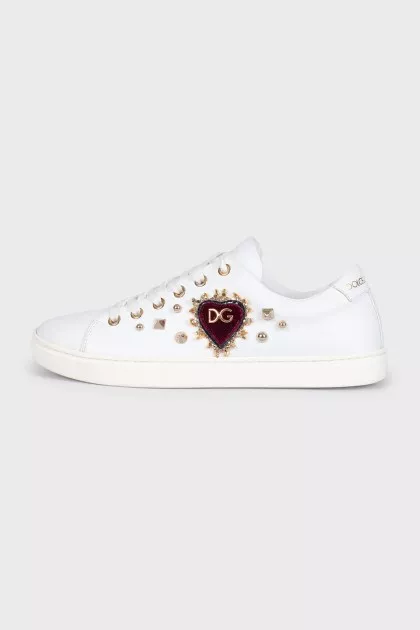 Leather sneakers decorated with a patch and studs
