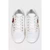 Leather sneakers decorated with a patch and studs