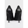 Black leather pointed toe pumps