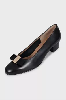 Black leather shoes decorated with a bow