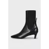 Black leather ankle boots with a square toe
