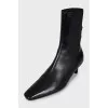 Black leather ankle boots with a square toe