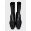Black leather ankle boots with a square toe