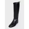 Black leather boots with signature buckle