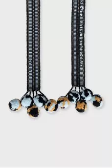 Blue textile belt with pom-poms
