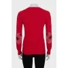 Red jumper with patches on the sleeves