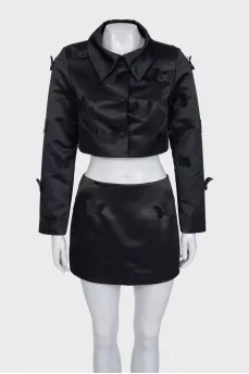 A suit consisting of a cropped jacket and a miniskirt