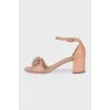 Beige patent leather sandals with a bow