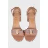 Beige patent leather sandals with a bow