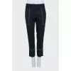 Black trousers with white stitching