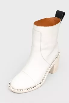 White boots with metal spikes