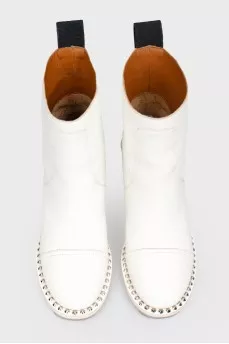 White boots with metal spikes