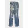Blue jeans with embroidery and a ripped effect