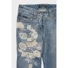 Blue jeans with embroidery and a ripped effect