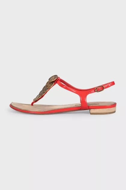 Red sandals with metallic decor