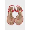 Red sandals with metallic decor