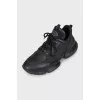 Black leather sneakers with shiny inserts