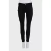 Skinny jeans with a signature brooch