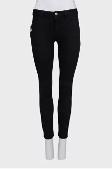 Skinny jeans with a signature brooch