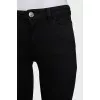 Skinny jeans with a signature brooch