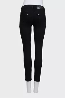 Skinny jeans with a signature brooch