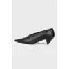 Black leather shoes with a sharp toe
