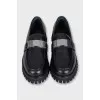 Black loafers with logo