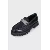 Black loafers with logo