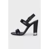 Black leather heeled sandals with silver hardware