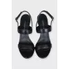 Black leather heeled sandals with silver hardware