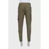 Men's green trousers with a branded patch