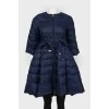 The dark blue jacket is flared up