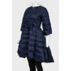 The dark blue jacket is flared up